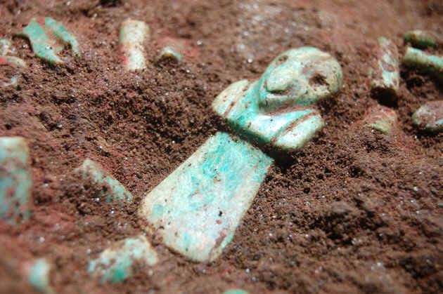 This photo taken on May 25, 2012, released on Thursday, Oct. 25, 2012 by Tak'alik Ab'aj Archaeological Project shows a jade piece in the tomb of a very early Mayan ruler at Tak'alik Ab'aj archaeological site in Retalhuleu, south of Guatemala City. Archaeologists in Guatemala announced Friday they have uncovered the tomb complete with rich jade jewelry and decoration. Government archaeologist Miguel Orrego says carbon-dating indicates the tomb was built between 700 and 400 B.C., several hundred years before the Mayan culture reached its apogee (AP Photo/Tak'alik Ab'aj Archaeological Project)