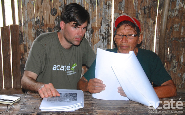 Chris Herndon (left) and Arturo, a shaman (right), look over drafts of the new encyclopedia. Photo courtesy of Acat.